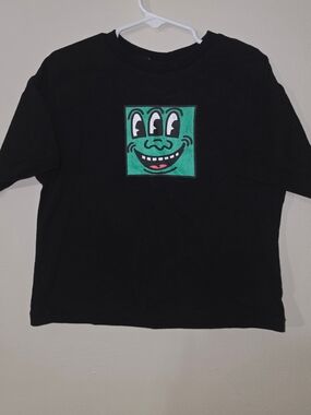 Primark Black Tee with Green Smiling Square Graphic